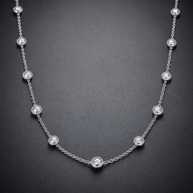Round rose cut diamonds by the yard with hand made mill grained bezels in 18 karat white gold