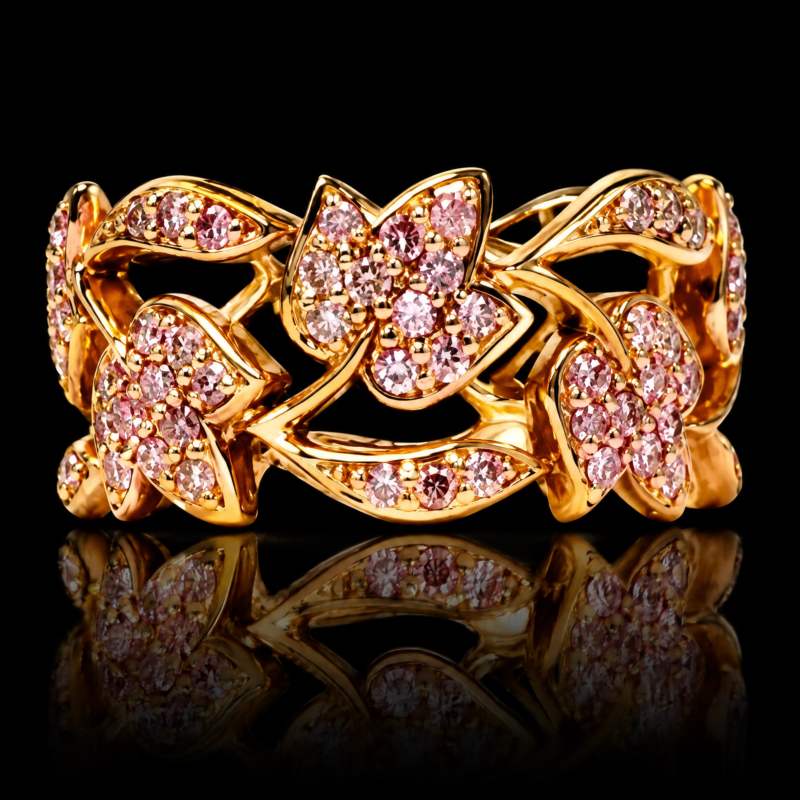 Tulip eternity band in 18 karat rose gold with natural fancy pink diamonds, openwork flowers and leaves, shown on black with reflection