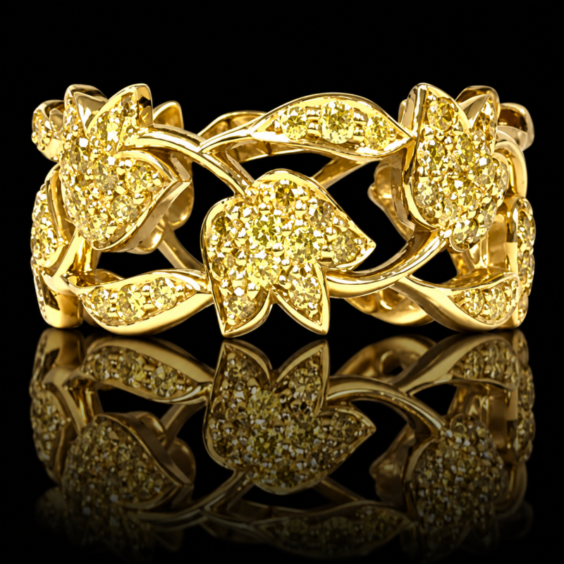 Tulip eternity band in 18 karat yellow gold with fancy yellow diamonds, openwork flowers and leaves, shown on a black background with reflection