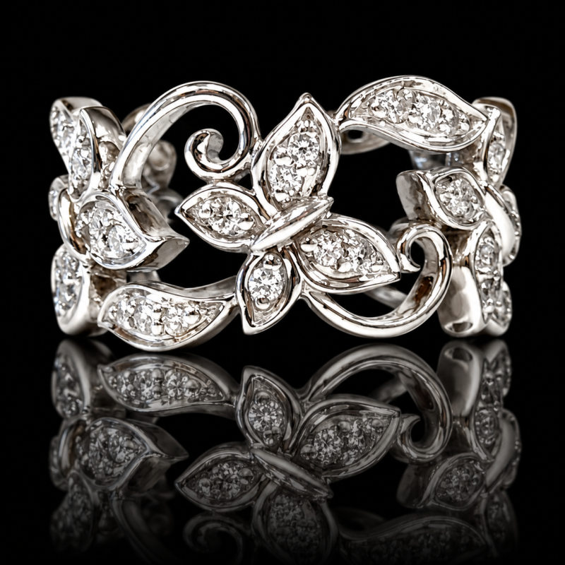 Platinum butterfly eternity band with white diamonds, leaf motifs and curling scrolls, reflected on a black background.